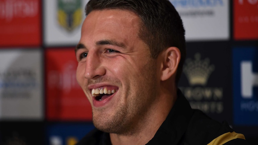 South Sydney Rabbitohs player Sam Burgess smiles at a press conference