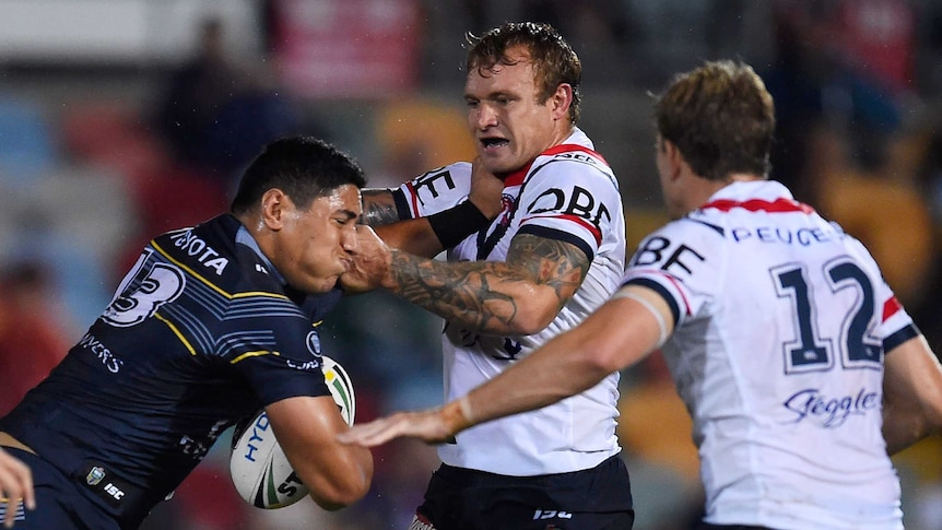 Jason Taumalolo of the Cowboys is tackled by Jake Friend of the Roosters during the round three NRL match