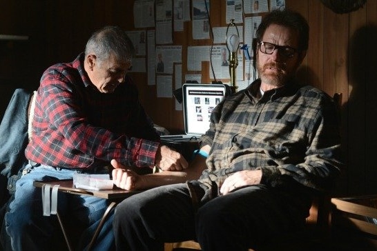Robert Forster inserts a needle into the arm of another character to take blood for a blood test