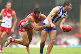 The Kangaroos' Luke McDonald is tackled by Sydney's Tom Derickx in round four at the SCG.