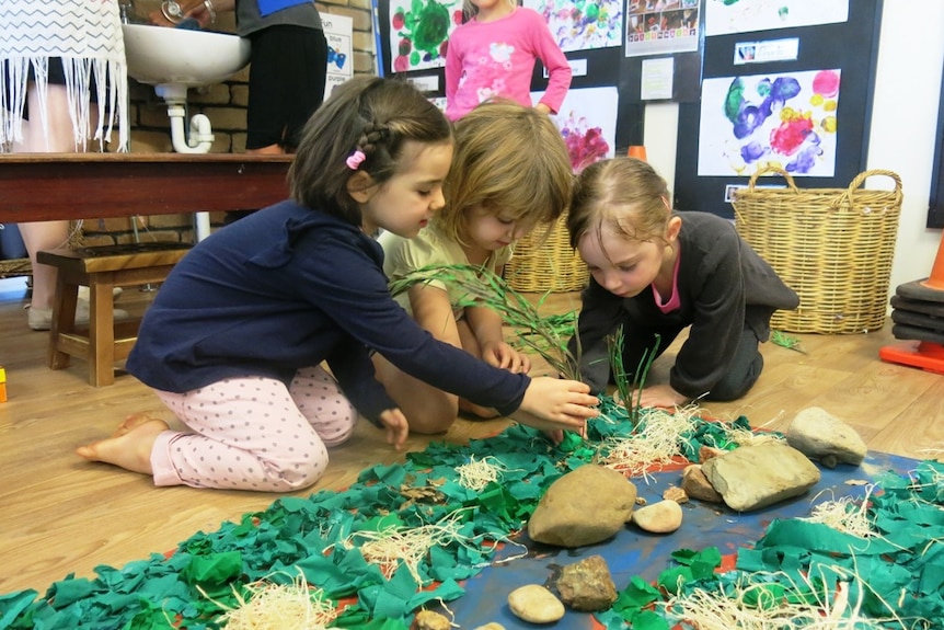 Three young girls working on a display cattle property.