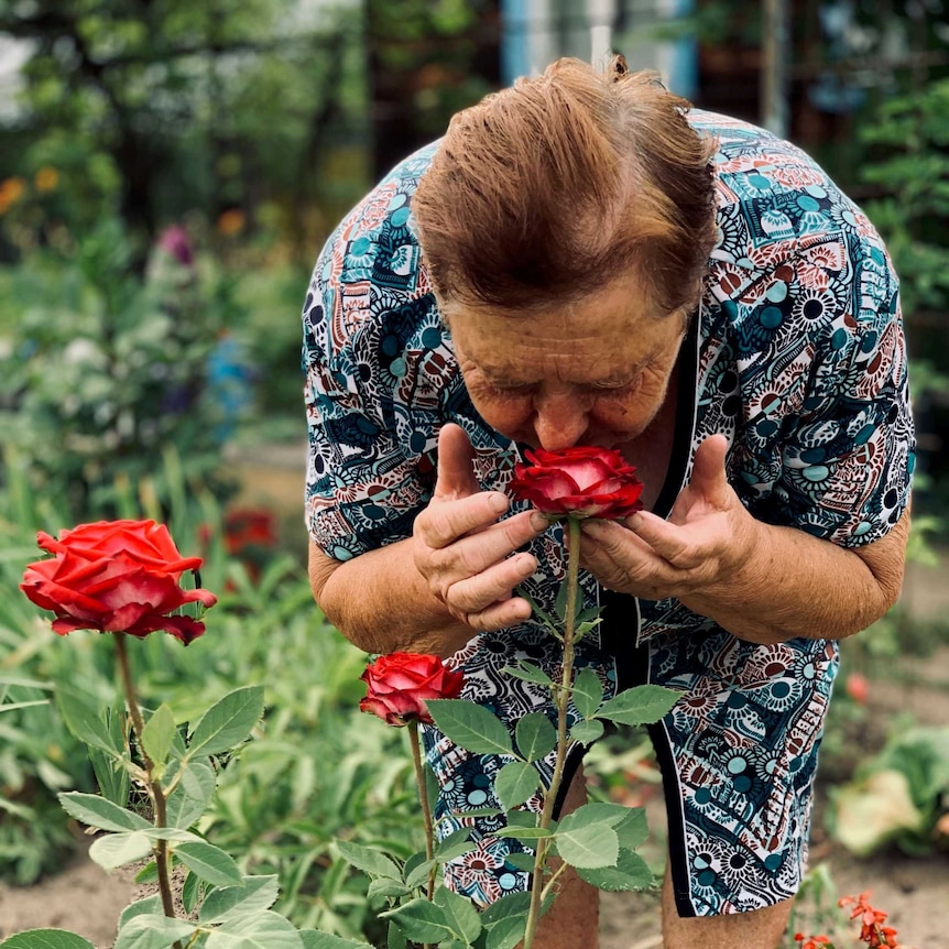 Sofia Bezverhaya smells the roses at her home inside the the Chernobyl exclusion zone.