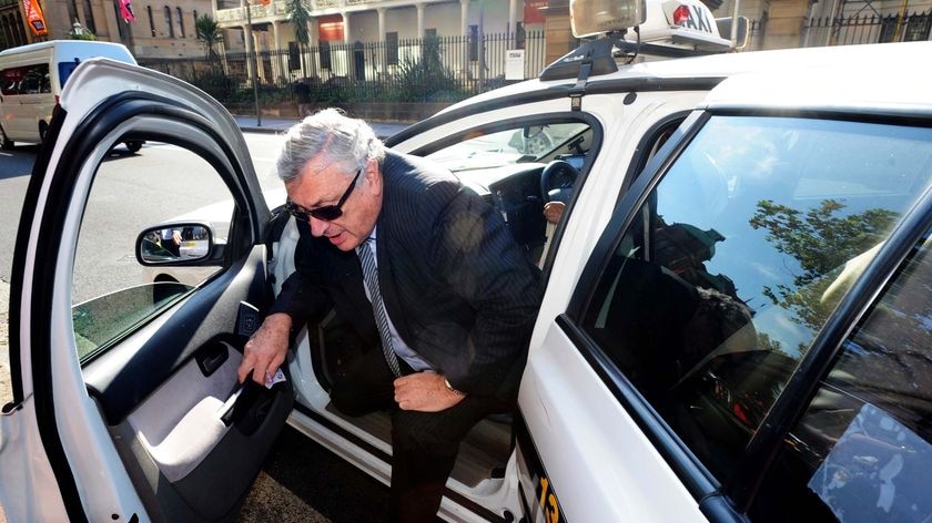 Disgraced former Federal Court judge Marcus Einfeld steps from a taxi as he arrives at court