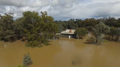 A homestead surrounded by floodwater in a drone image