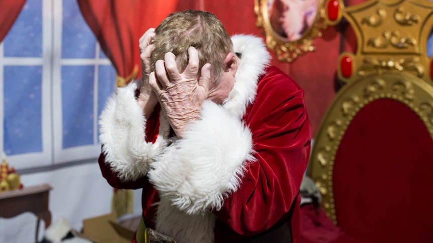 Santa Peter scratches his scalp after removing his Santa wig and hat, which make him "incredibly itchy".