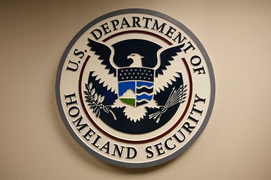 The US Department of Homeland Security emblem on a wall.