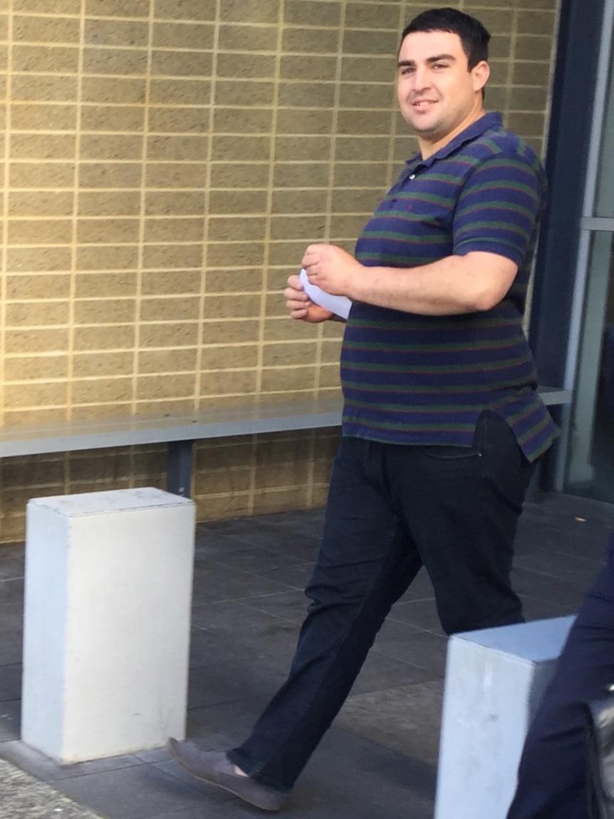 Tyrone Briffa smiles as he looks at the camera while walking out of Fremantle Magistrates Court.