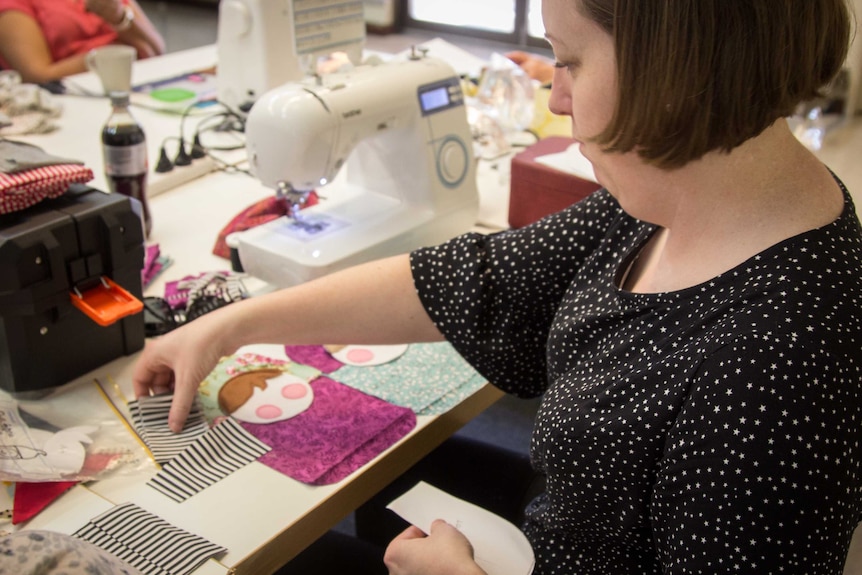 Sarah Mummé works on sewing a soft toy.