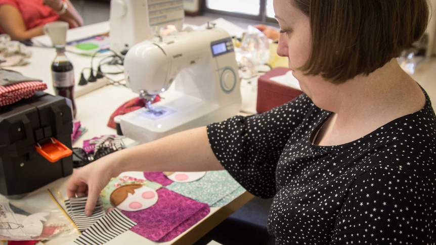Sarah Mummé works on sewing a soft toy.