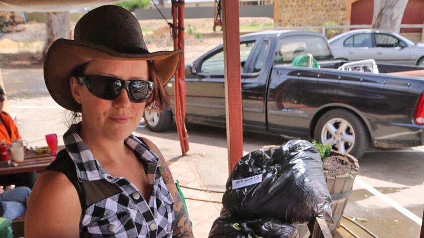 Sara Atkinson with clothing packaged for people in need