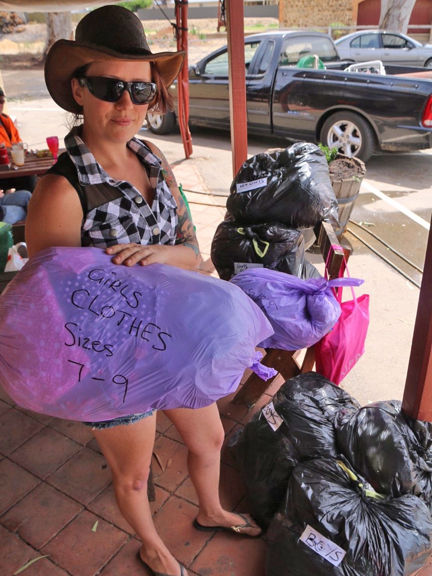 Sara Atkinson with clothing packaged for people in need