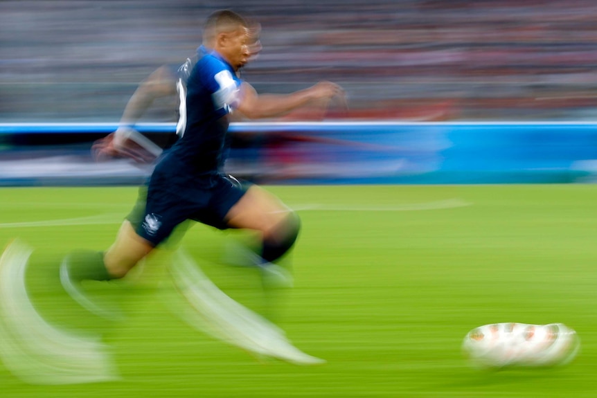Kylian Mbappe runs with the ball for France