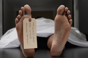 Cadaver on autopsy table, label tied to toe, close-up (Thinkstock: Digital Vision)