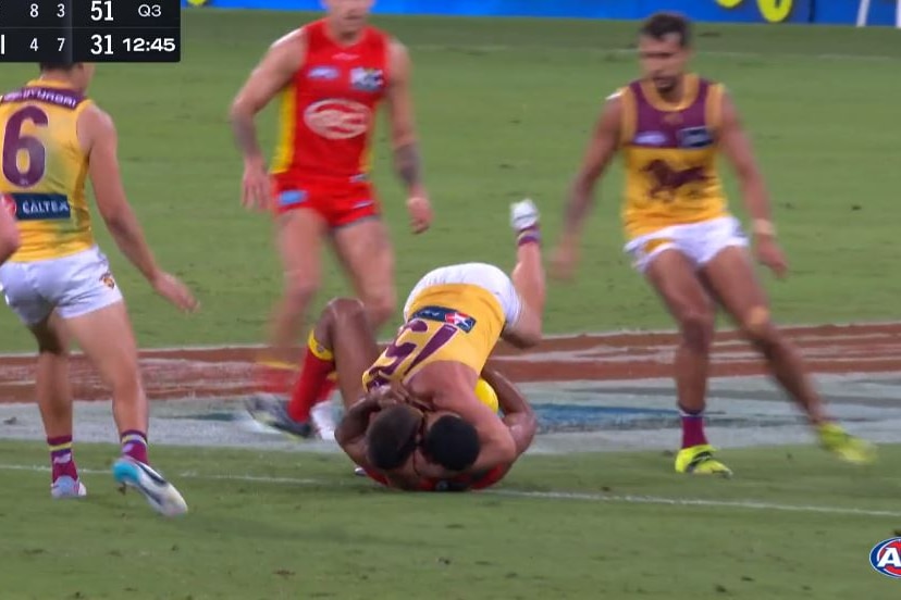 Dayne Zorko is on top of Touk Miller in a screenshot from TV footage of a game