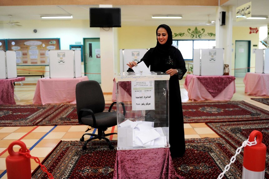 A woman casts her vote in Saudi Arabia.