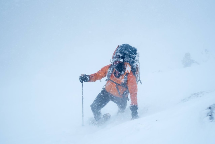 An Ambulance Tasmania officer in the snow