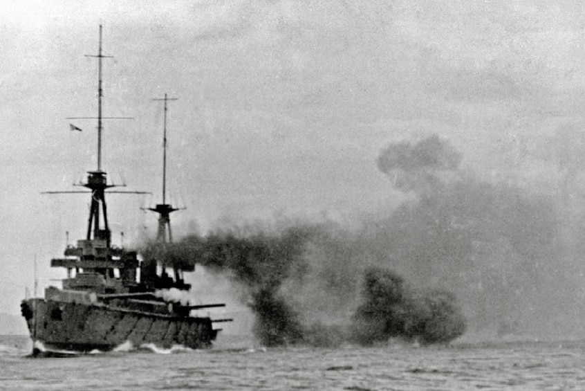 A big ship firing guns