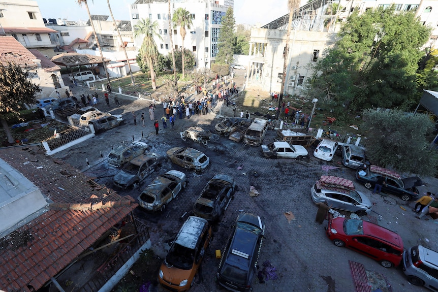 A courtyard of a hospital showing burned out cars and fire damage.