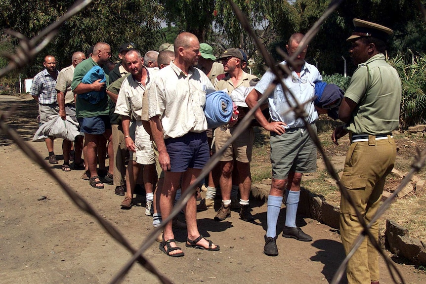 21 white farmers queue up as they're released from jail