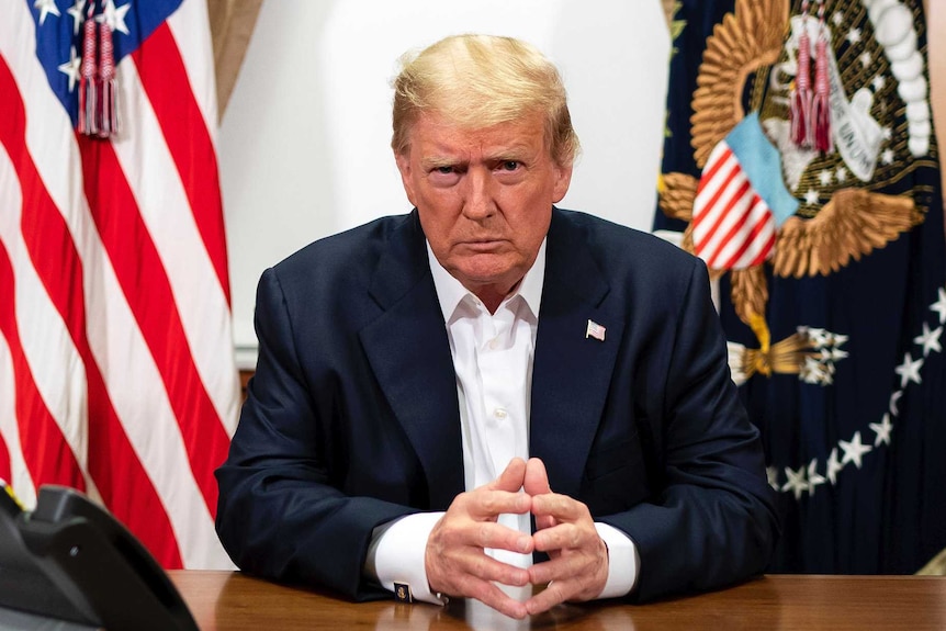 President Donald Trump listens during a phone call with Vice President Mike Pence from inside Walter Reed.