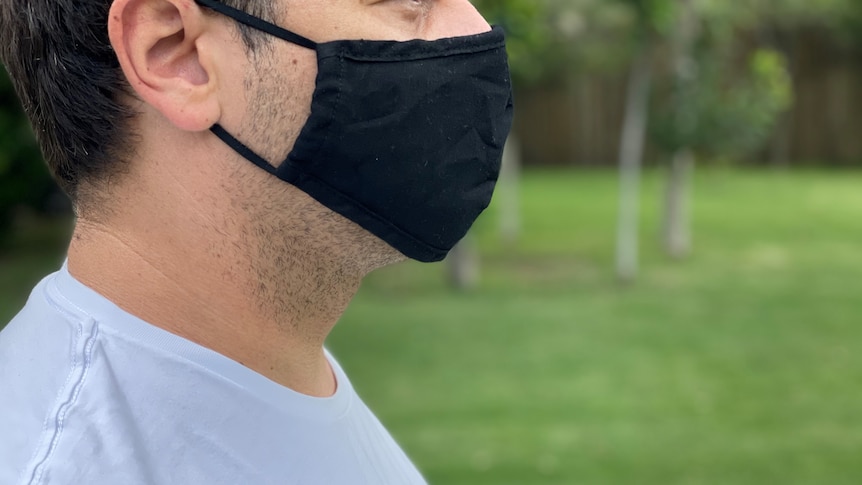 Profile of man wearing black mask