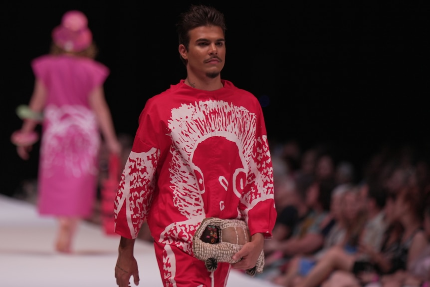a male model wearing a red outfit 