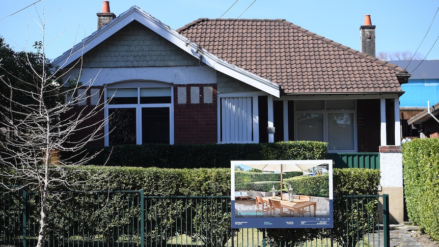 a for sale sign outside a house