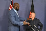 Shaquille O’Neal at a lectern with Anthony Albanese