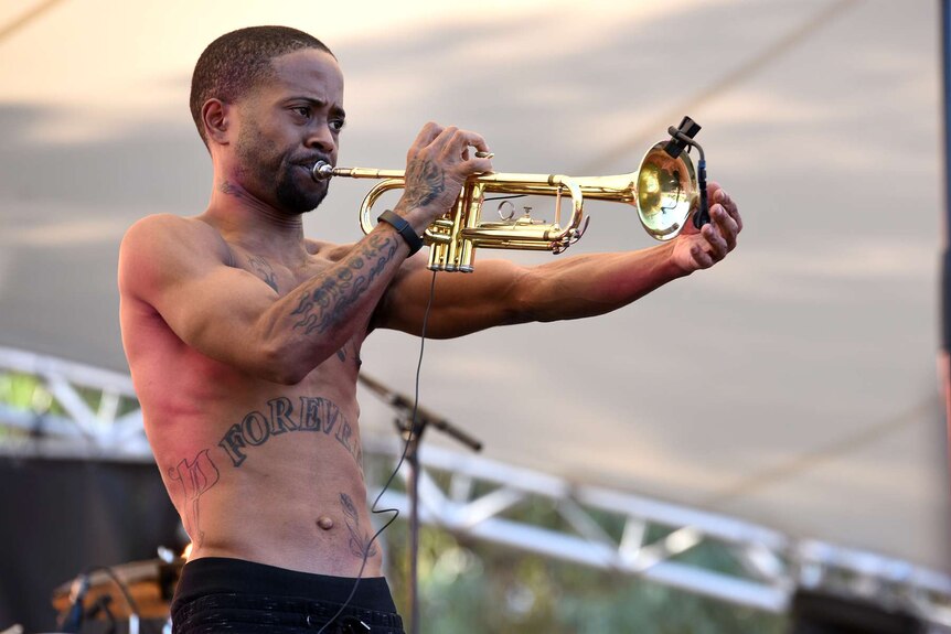 A trumpet player from the Hypnotic Brass Ensemble on stage at Womadelaide.