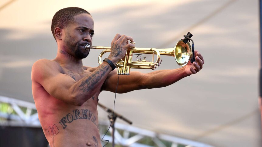 A trumpet player from the Hypnotic Brass Ensemble on stage at Womadelaide.