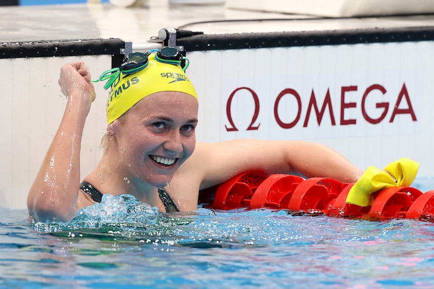 A woman wearing a yellow cap in a pool