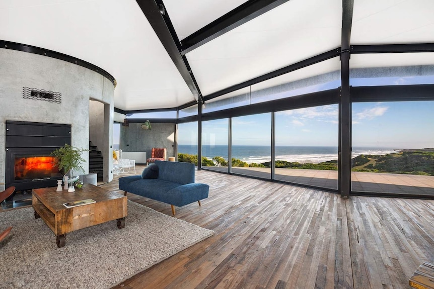 Loungeroom with fireplace overlooking a beach