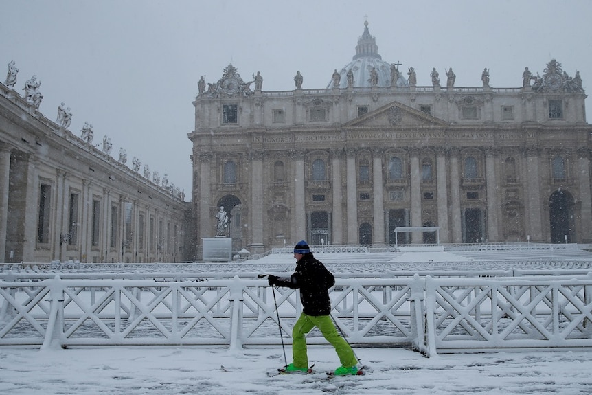 A man skis in front of Saint Peter's Square at the Vatican.