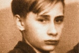 A sepia photo of a young boy, looking serious.