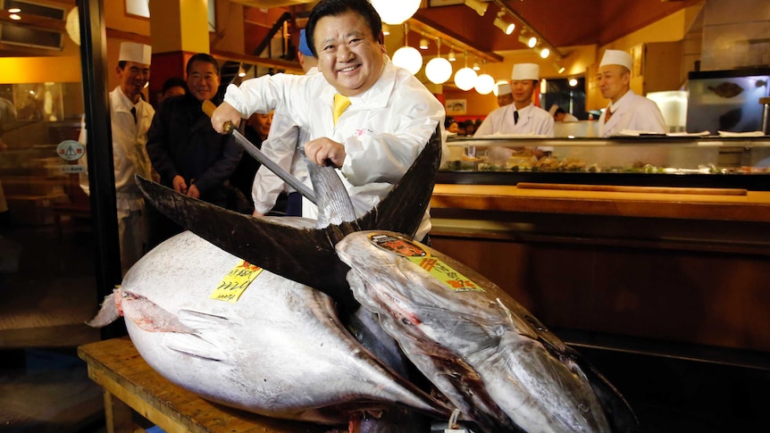 Kiyoshi Kimura, who runs a chain of sushi restaurants, poses with a bluefin tuna
