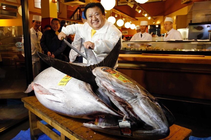 Kiyoshi Kimura, who runs a chain of sushi restaurants, poses with a bluefin tuna