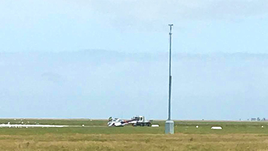 A light plane is towed by a truck after crashing at the Port Pirie Aerodrome