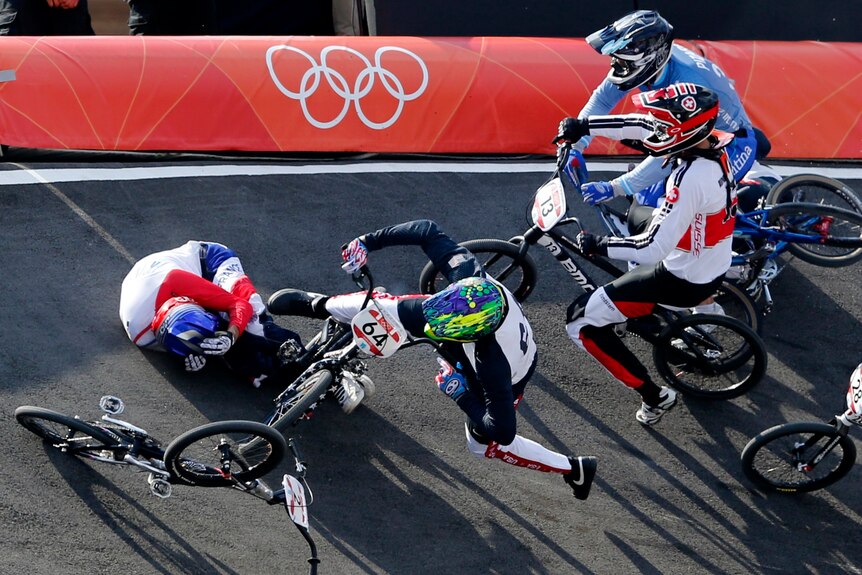 France's Joris Daudet (L) and Nicholas Long of the US fall during the men's BMX quarter-final run