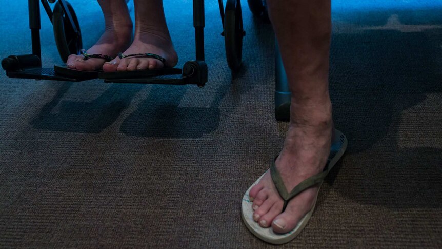 Sue and Peter's feet in thongs while they wait for a radiotherapy appointment.