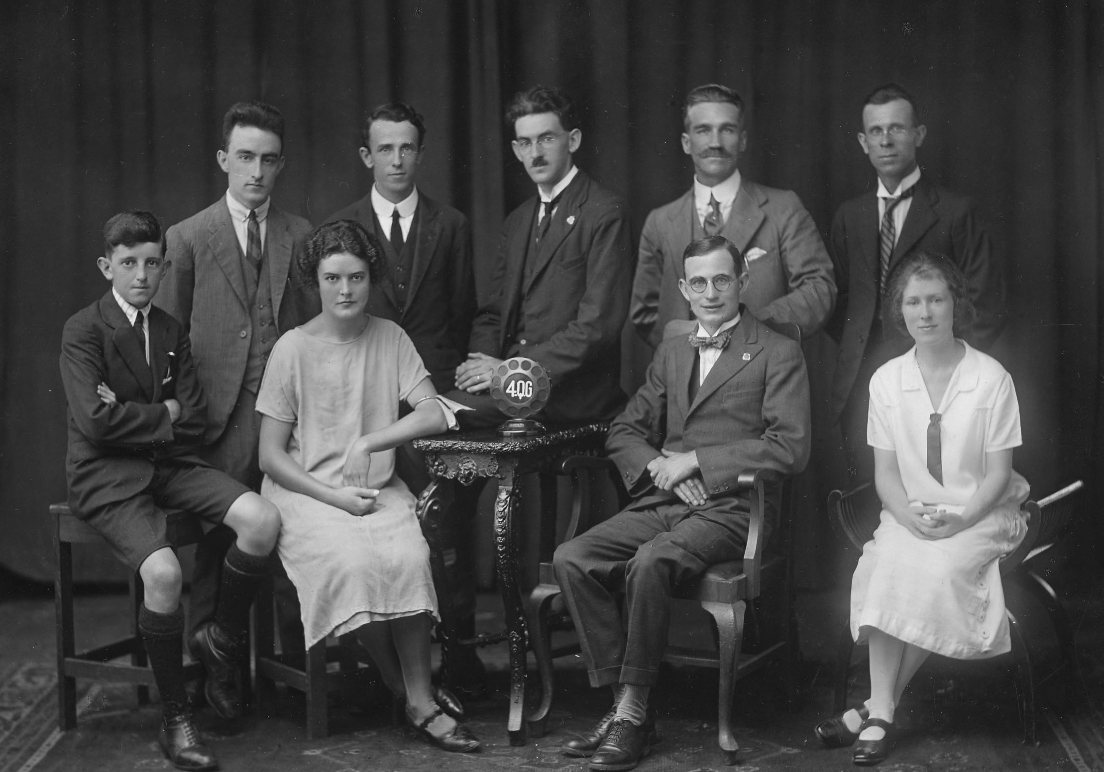 A black and group photo with formally dressed men and women.