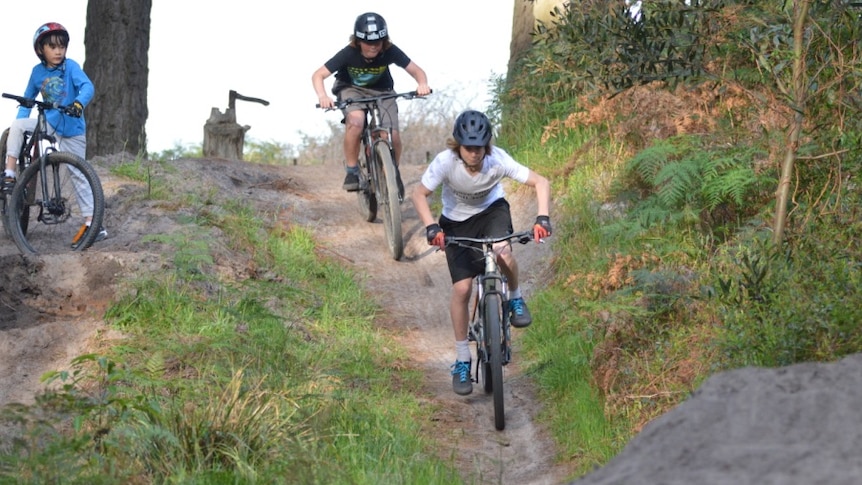 three bike riders on hell track