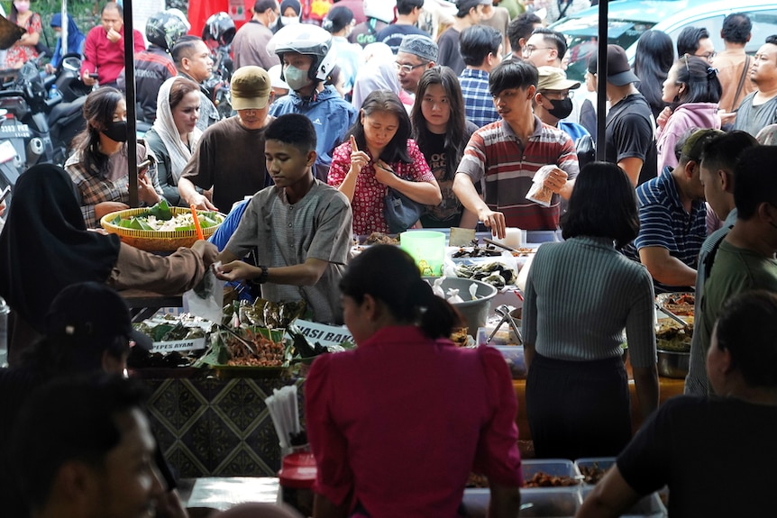 A crowd queing for snacks in Indonesia during Ramadan.