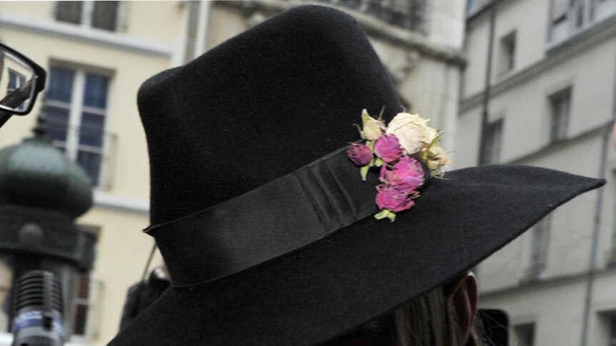 Fashion designer Galliano arriving at a French police station.