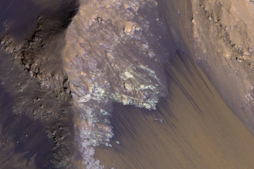 Flows on a slope within Coprates Chasma, which is part of the grandest canyon system on Mars