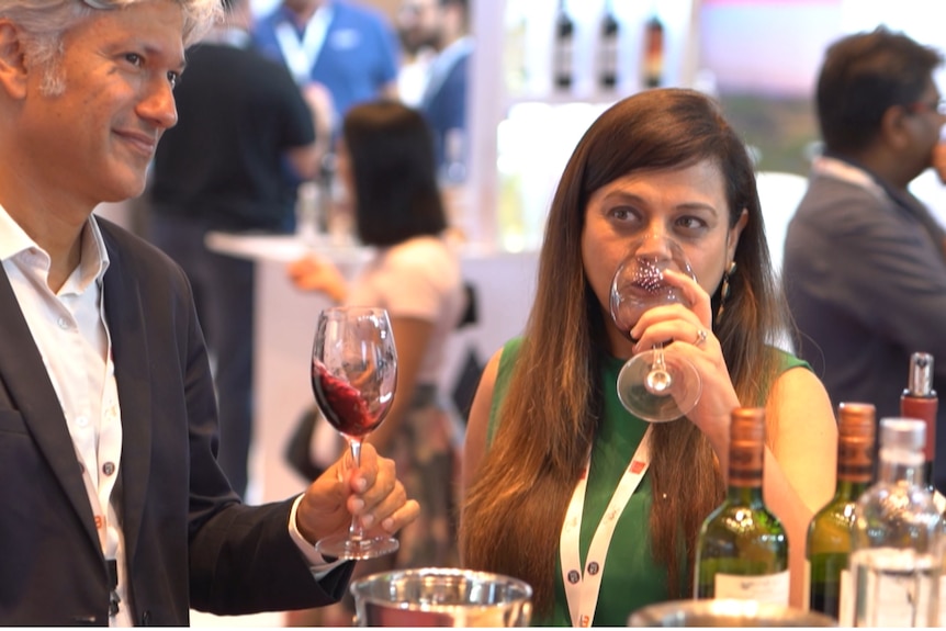 Photo of two people drinking wine.