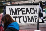 A ute with an Impeach Trump sign