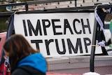 A ute with an Impeach Trump sign