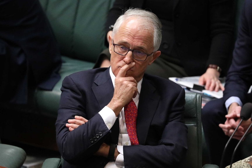 Malcolm Turnbull holds his finger to his face