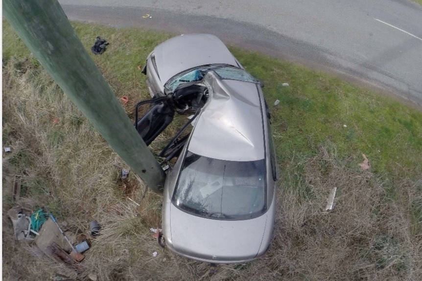 A view of the top of a car crashed into a power pole killing a passenger.