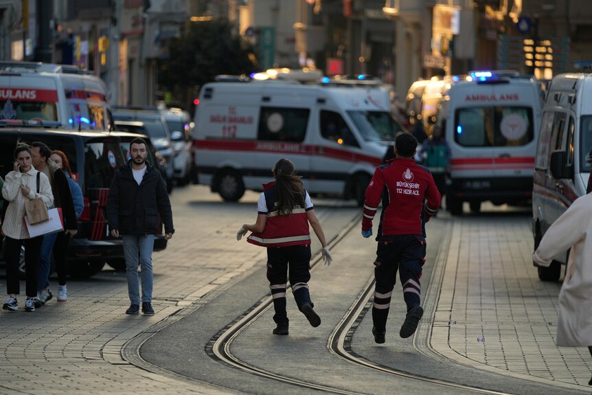 Paramedics run to the scene of an explosion.